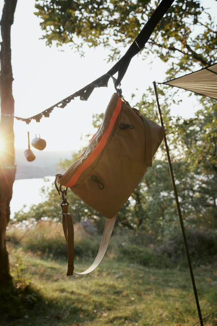 ELLIKER Selside Sacoche Bag hanging from line in sunset