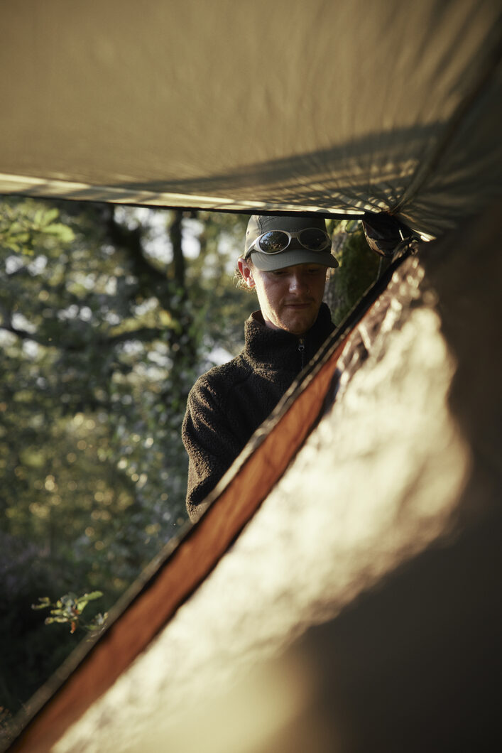 Close up of Marcus setting up hammock